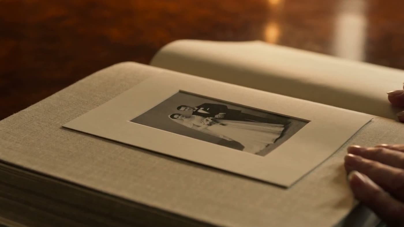 An open linen-bound memoir with a restored family photograph