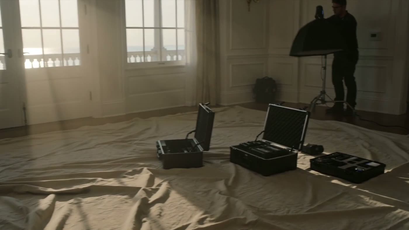 A small film crew setting up in a private home